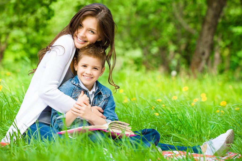 Mother and son with a book sitting in the New Forest Ringwood Family Photography