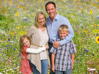 Portrait,Of,Family,On,Walk,Through,Field,Of,Summer,Flowers