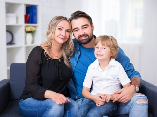 Happy,Family,Portrait,-,Couple,And,Little,Son,Sitting,On
